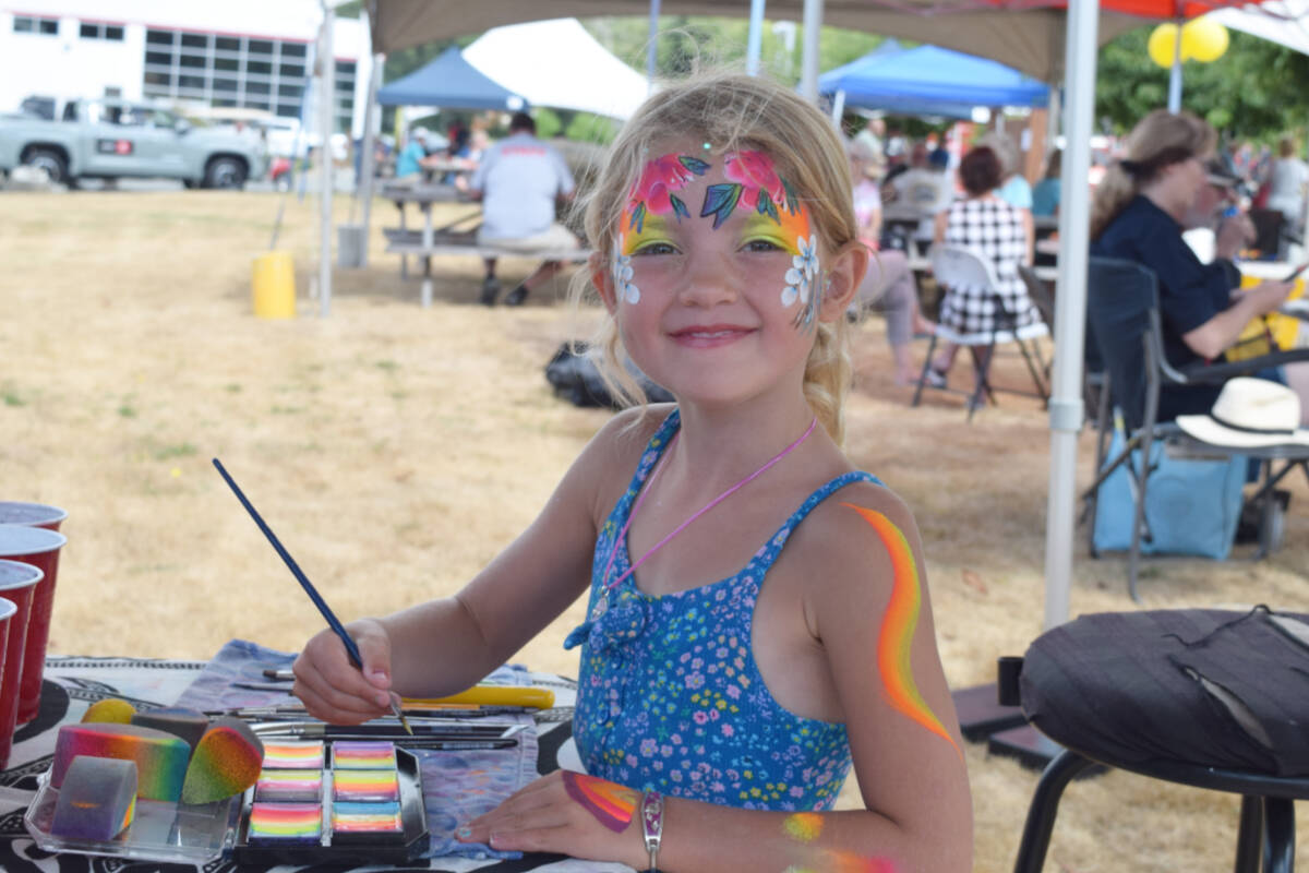 Anneli Orser experiments with body art courtesy of Ethereal Face Painting at the Alberni Auto Group show 'n shine on Saturday, Aug. 27. Ethereal Face Painting will be at the Alberni District Fall Fair this weekend.  (ELENA RARDON / ALBERNI VALLEY NEWS)