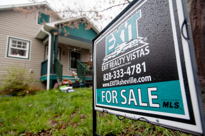 This file photo shows a 'for sale' sign in front of a home in March 2021. A new report from Allen Tate/Beverly-Hanks says the regional market is strong for sellers, despite sales dips from last year.