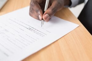 Man signing contract;  image by Cytonn Photography, via Unsplash.com.