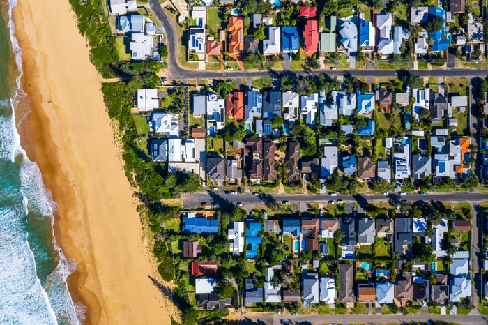Aerial view of houses built along a coastline.