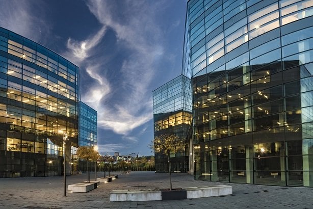 low skyscrapers in business park lit at dusk