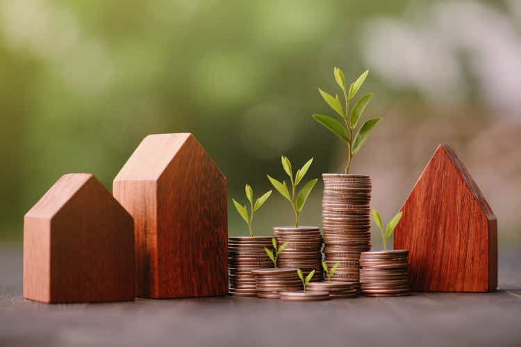 Investment in the real estate business.  Money coin stack growing graph and wood house model.  Loans for the purchase of residential houses.  Save for the future.