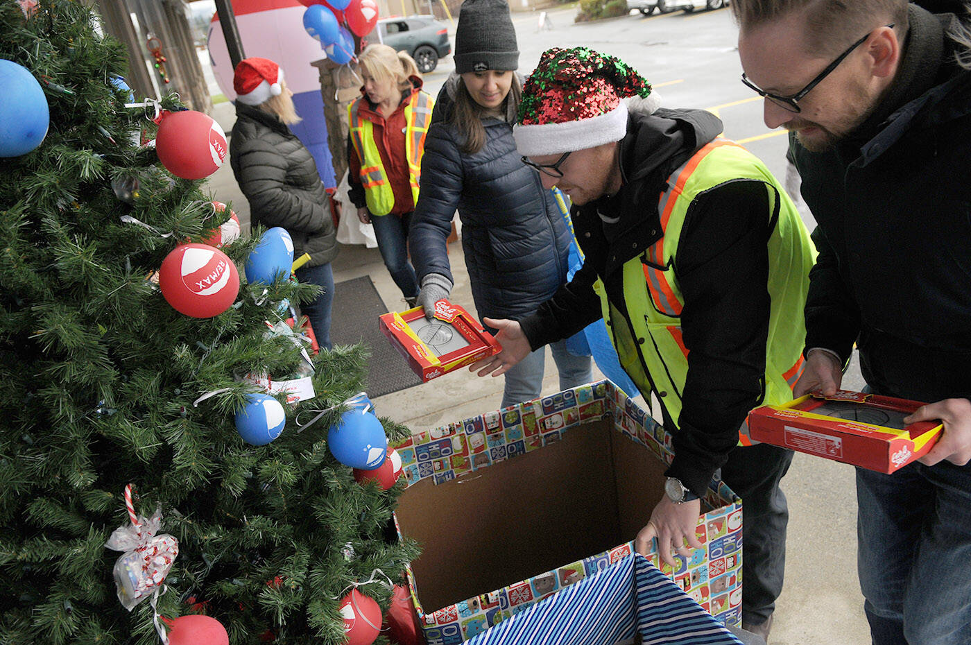 People with Remax Nyda Realty collect gifts during the annual Toy House at their office on Vedder Road on Saturday, Dec.  10, 2022. (Jenna Hauck/ Chilliwack Progress)