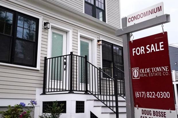 Condominium units are offered for sale in the Dorchester neighborhood, Wednesday, Aug. 18, 2021, in Boston.  Sales of previously occupied US homes fell in February as competition for a near-record low number of properties on the market drove prices higher and rising mortgage rates kept would-be buyers on the sidelines.  The National Association of Realtors said Friday, March 18, 2022 that existing home sales fell 7.2% last month from January to a seasonally adjusted annual rate of 6.02 million.  (AP Photo/Charles Krupa)